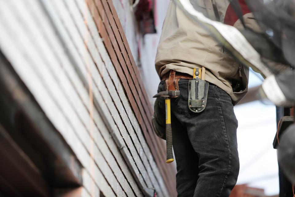 A builder checking a phone on site