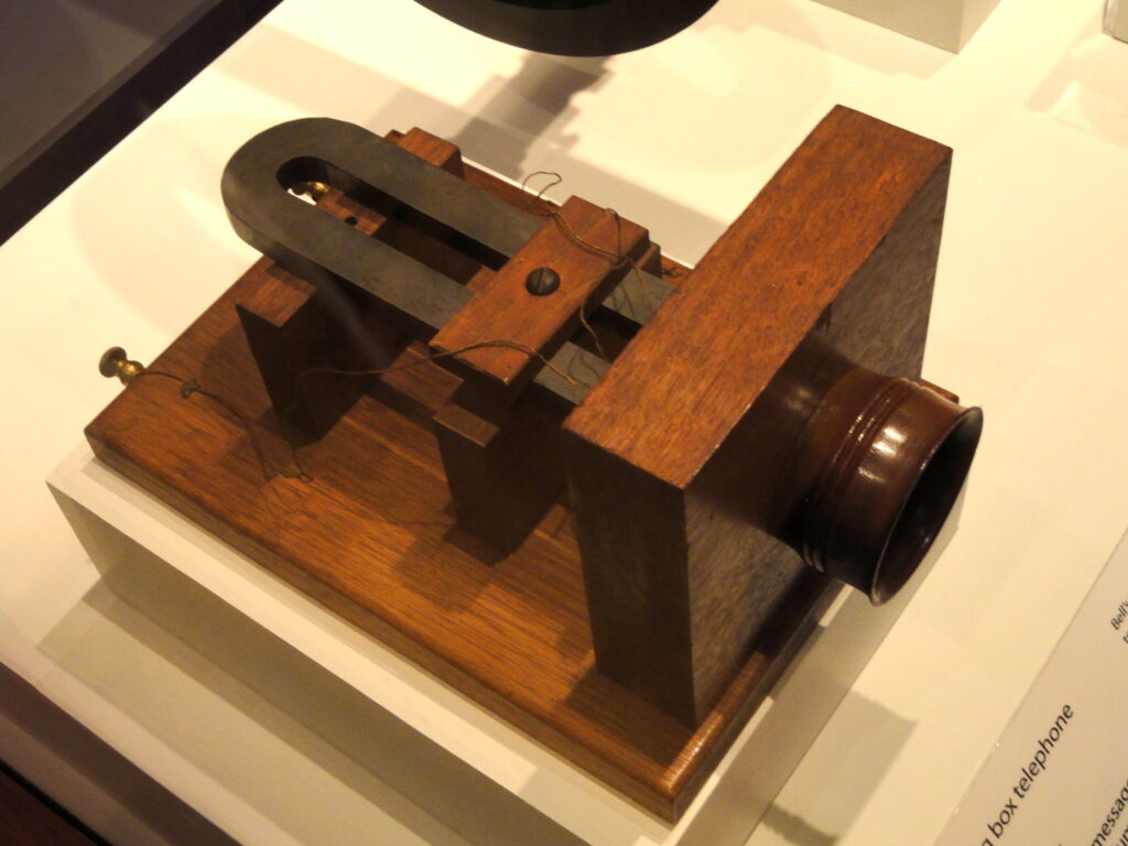 A telephone beside paperwork on an office desk